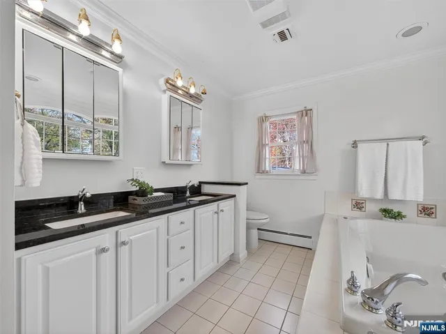 a spacious bathroom with a granite countertop sink a mirror and a
