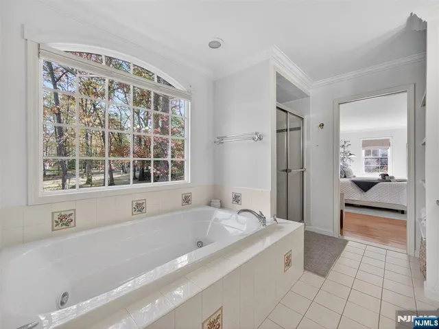 a spacious bathroom with a bathtub and a shower