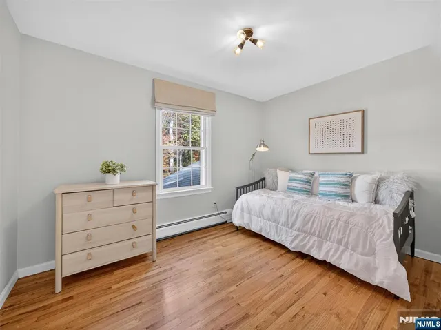 a spacious bedroom with a bed and a window