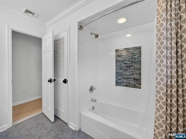 a bathroom with a bathtub and a shower