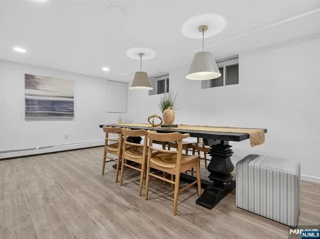 a dining room with furniture and wooden floor
