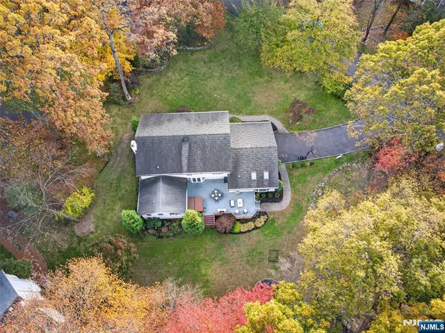 an aerial view of a house with a garden and yard