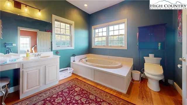 a bathroom with a sink toilet and window