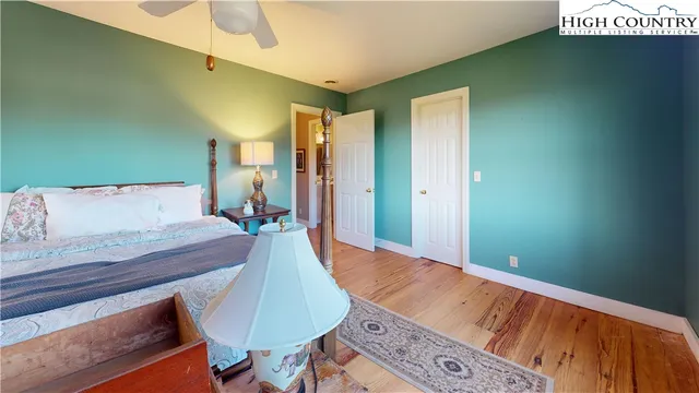 a spacious bedroom with a bed and a table in it