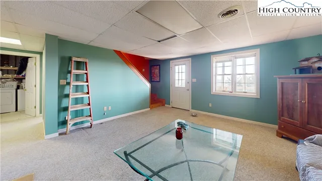 a view of a livingroom with furniture and windows