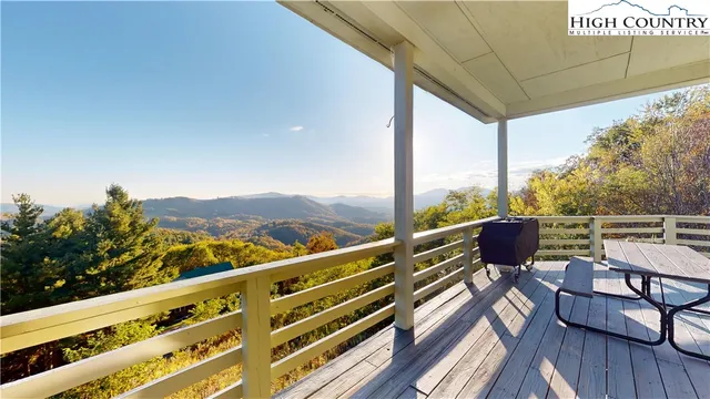 a view of balcony with mountain view and wooden floor