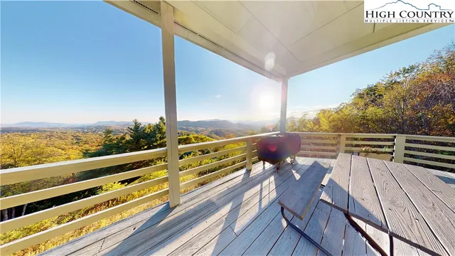 a view of balcony with wooden floor and outdoor seating