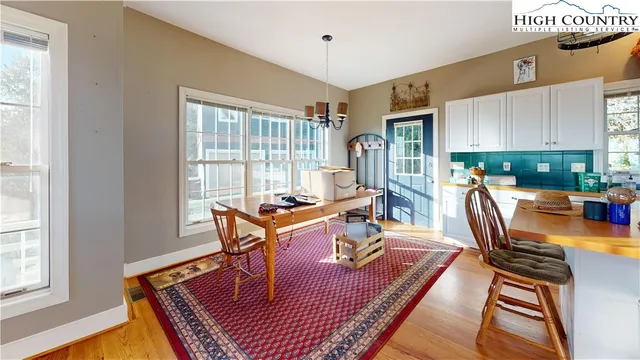 a living room with furniture a rug and a window