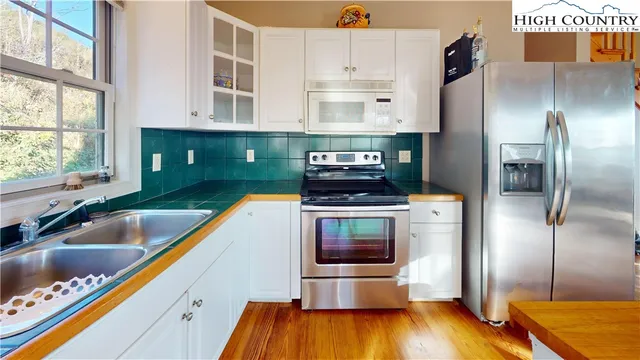 a kitchen with kitchen island a counter top space a sink and stainless steel appliances