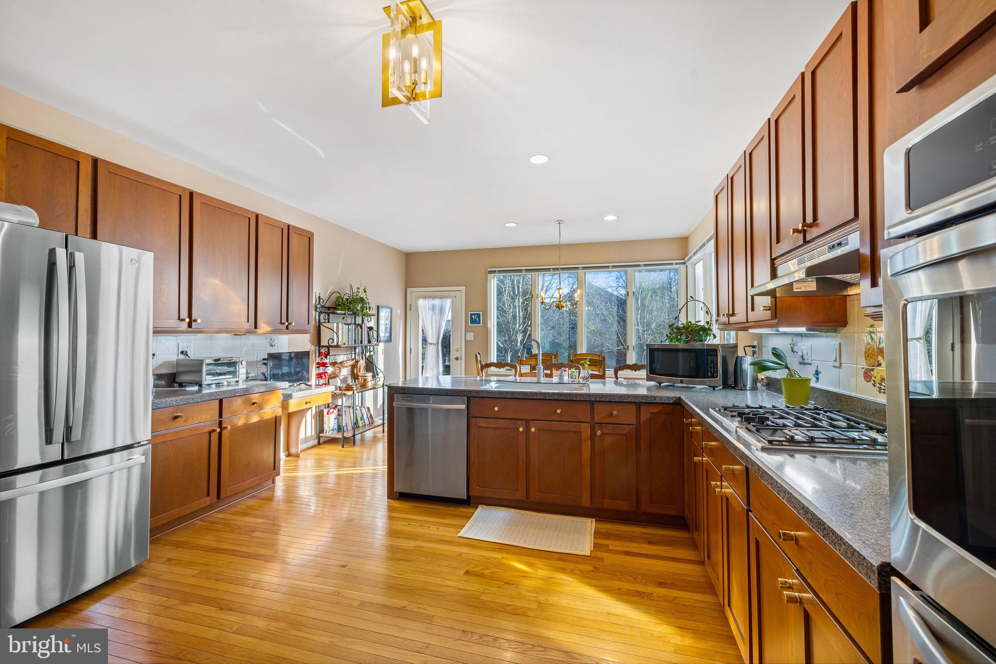 9 Jazz Way Mount Laurel, NJ 08054 - Photo 12 of 36 a kitchen with stainless steel appliances granite countertop a refrigerator a stove top oven a sink dishwasher and wooden cabinets with wooden floor