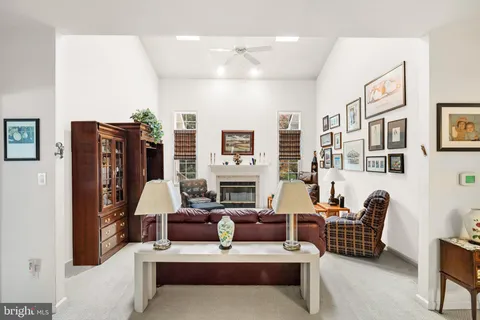 a living room with furniture or chandelier and a large window