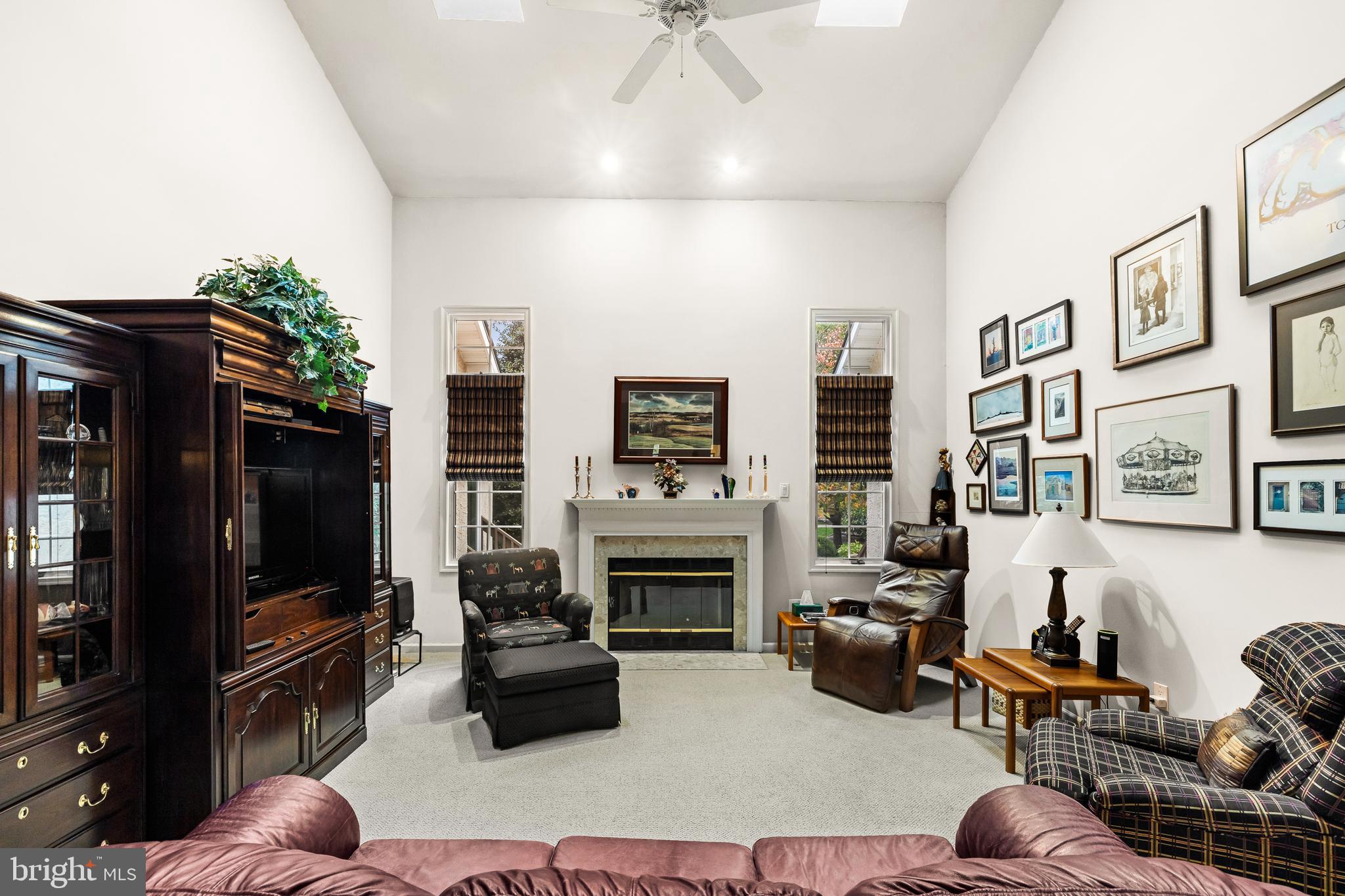 9 Jazz Way Mount Laurel, NJ 08054 - Photo 18 of 36 a living room with furniture a flat screen tv and a fireplace