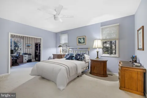 a bedroom with bed and window