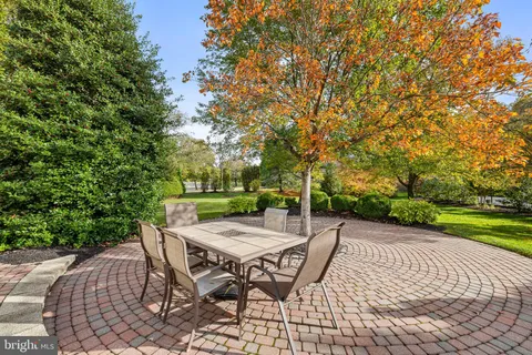 a view of a patio with table and chairs and couches