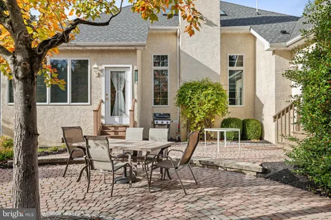 a view of outdoor dining space with a table and chairs