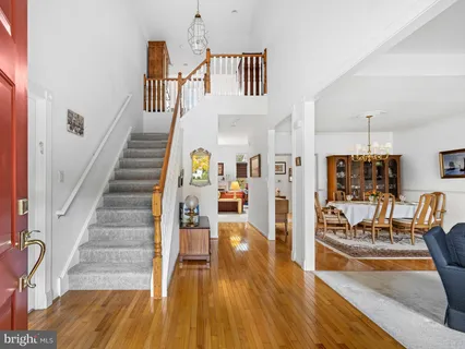 a view of entryway livingroom and hall with wooden floor