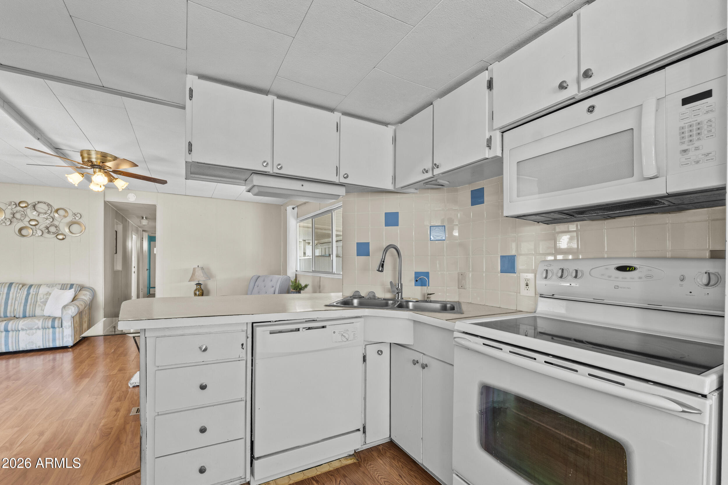 2460 East Main Street, Unit D2 Mesa, AZ 85213 - Photo 10 of 27 a kitchen with cabinets appliances a sink and a counter top space