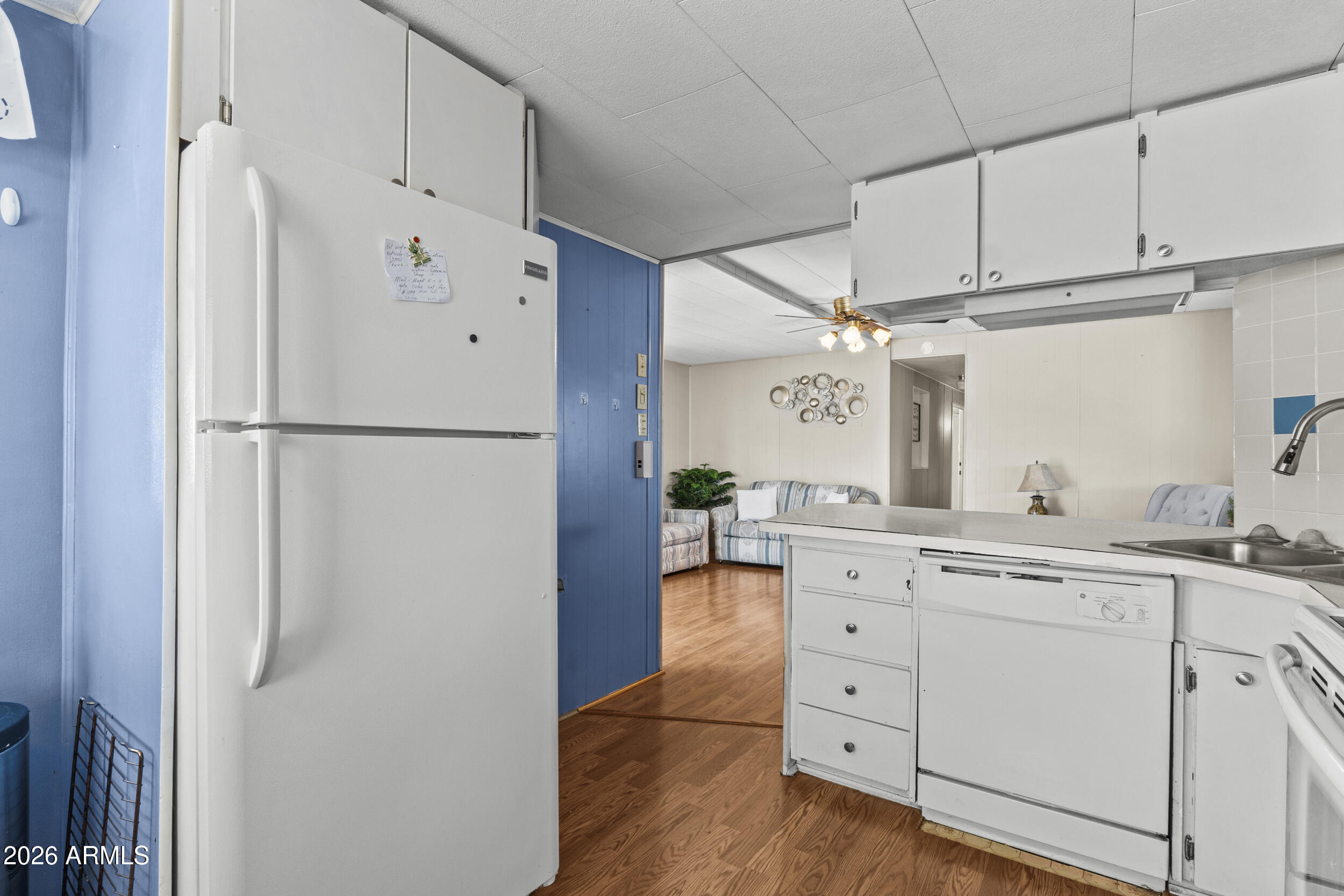 2460 East Main Street, Unit D2 Mesa, AZ 85213 - Photo 11 of 27 a kitchen with cabinets stainless steel appliances and a refrigerator