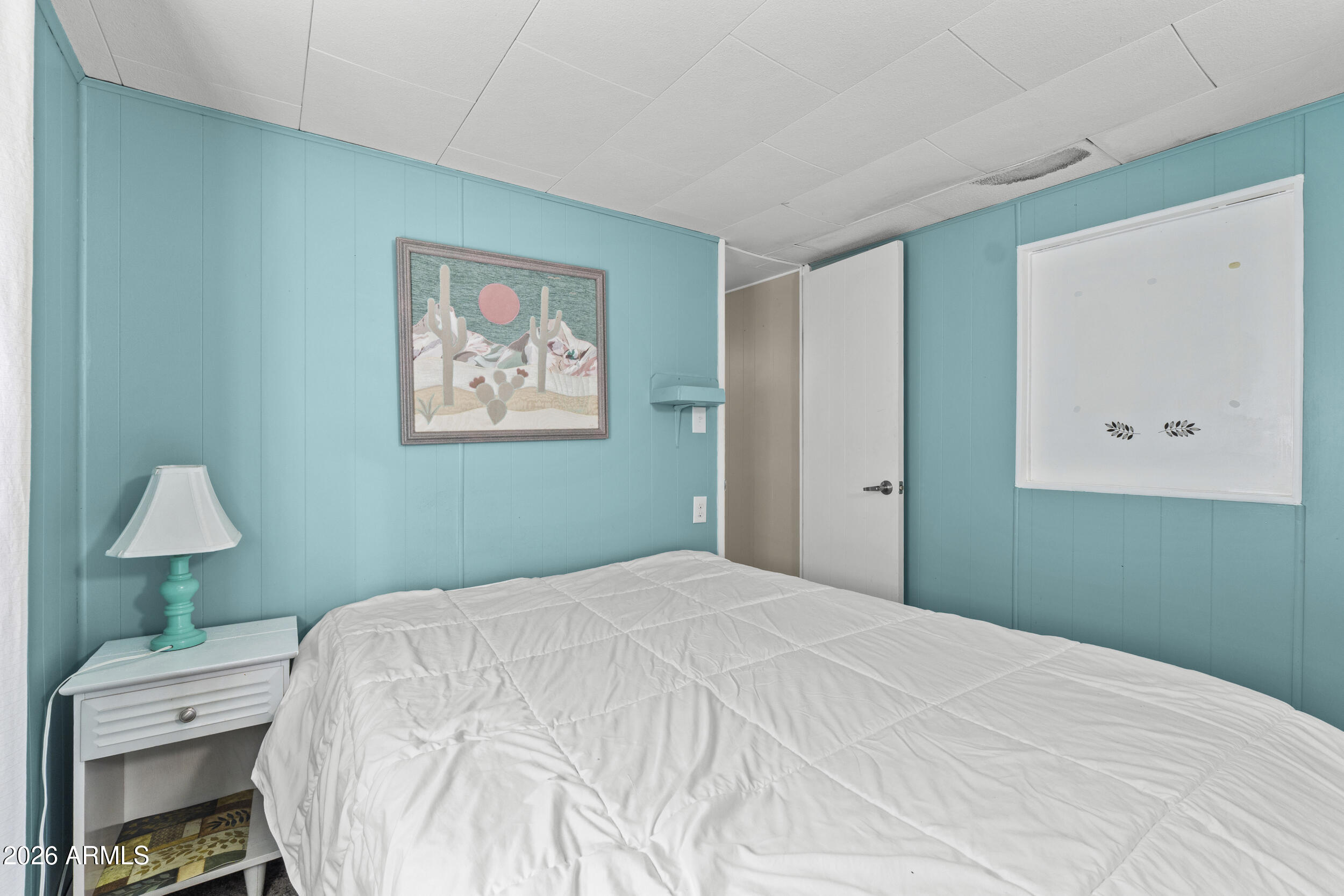 2460 East Main Street, Unit D2 Mesa, AZ 85213 - Photo 20 of 27 a bedroom with a bed and a lamp on table