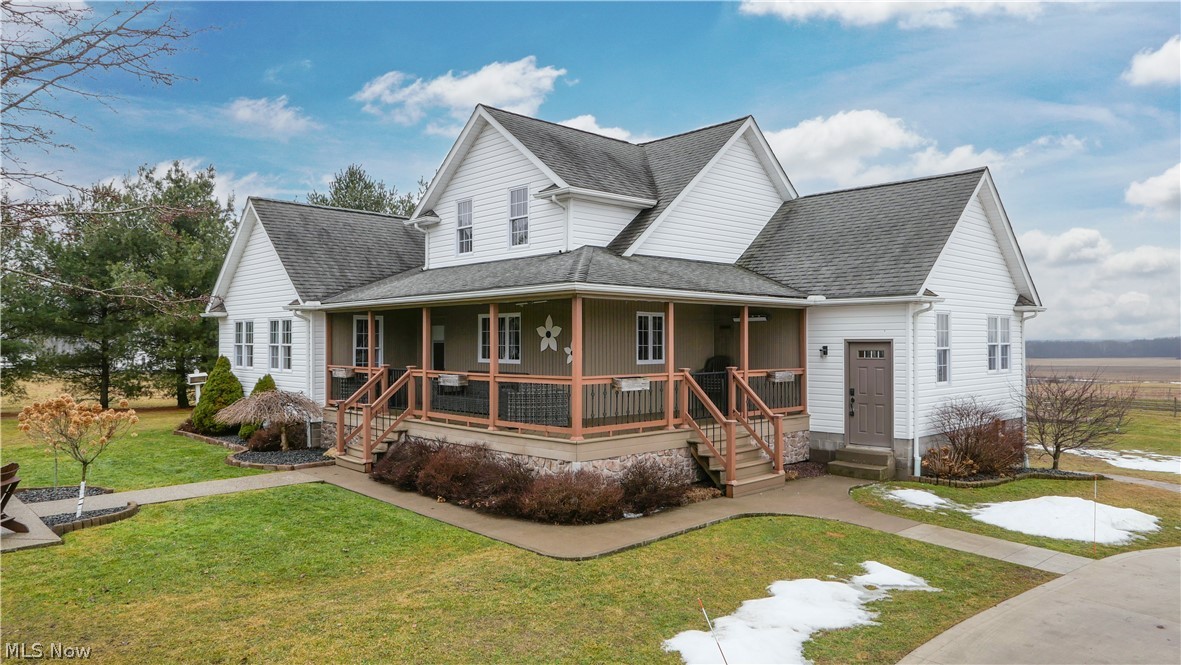 9561 Creaser Road North Bloomfield, OH 44450 - Photo 25 of 45 Farmhouse-style home with a shingled roof, covered porch, and a front lawn