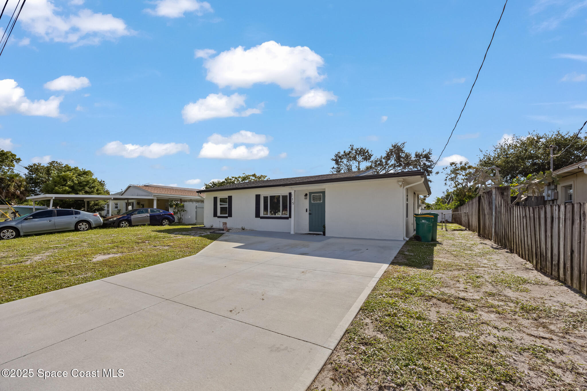 115 Primrose Lane Melbourne, FL 32901 - Photo 11 of 22 a front view of a house with a yard and garage