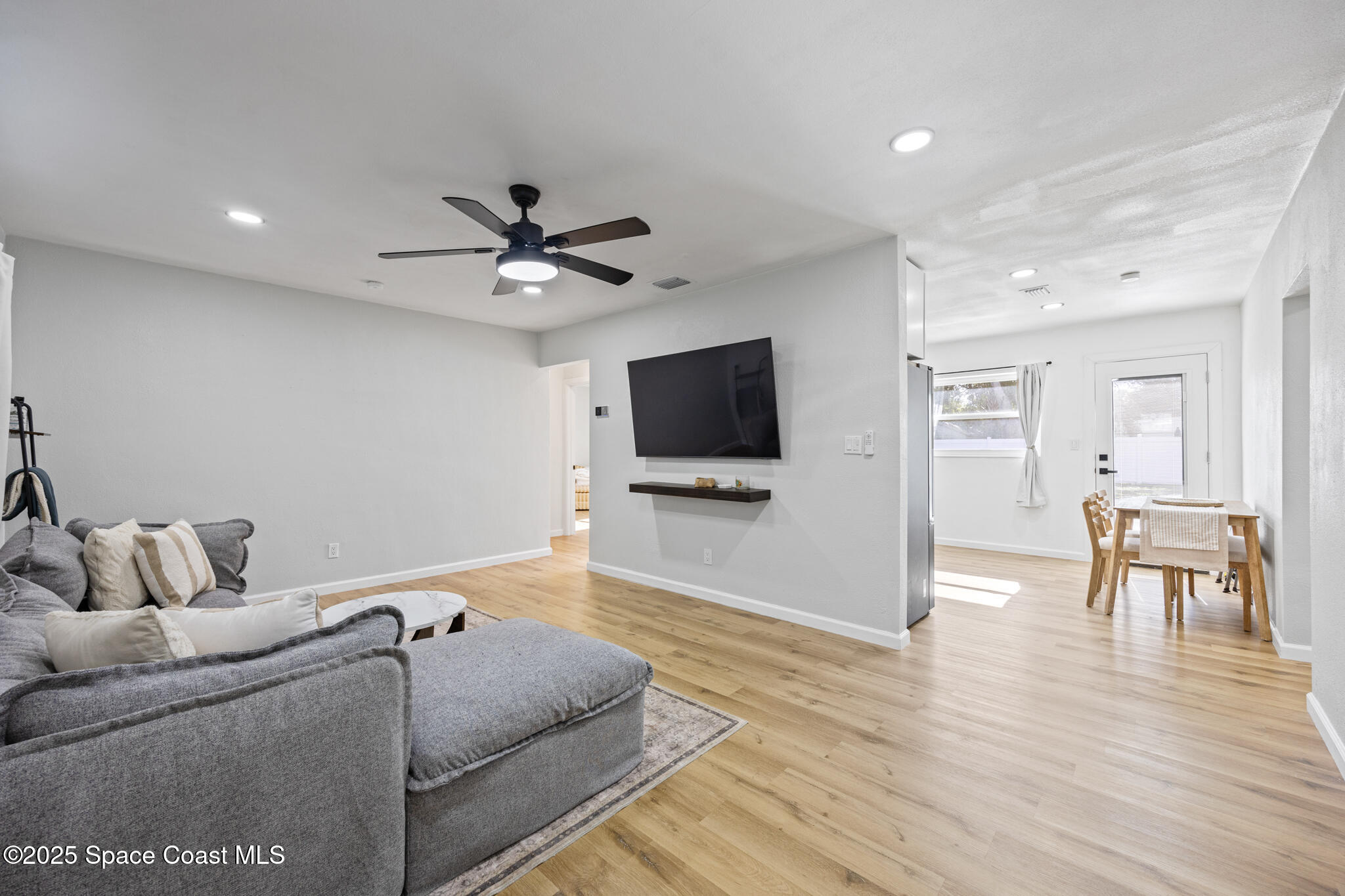 115 Primrose Lane Melbourne, FL 32901 - Photo 18 of 22 a living room with furniture and a flat screen tv