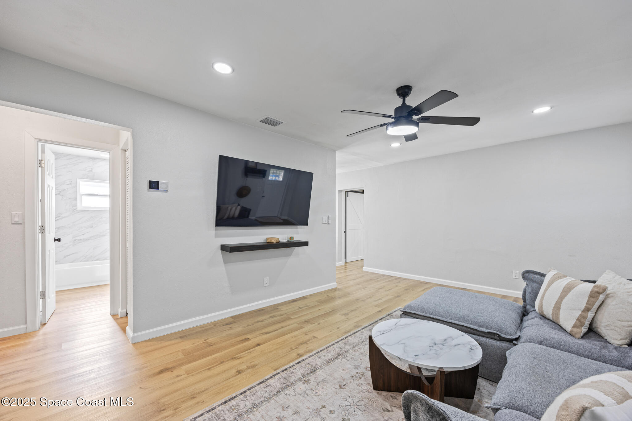 115 Primrose Lane Melbourne, FL 32901 - Photo 19 of 22 a living room with furniture and a flat screen tv