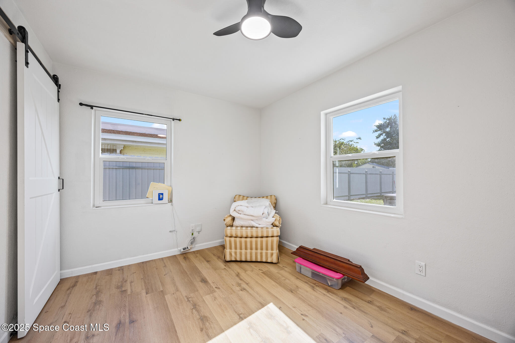 115 Primrose Lane Melbourne, FL 32901 - Photo 20 of 22 a bedroom with a bed and a window
