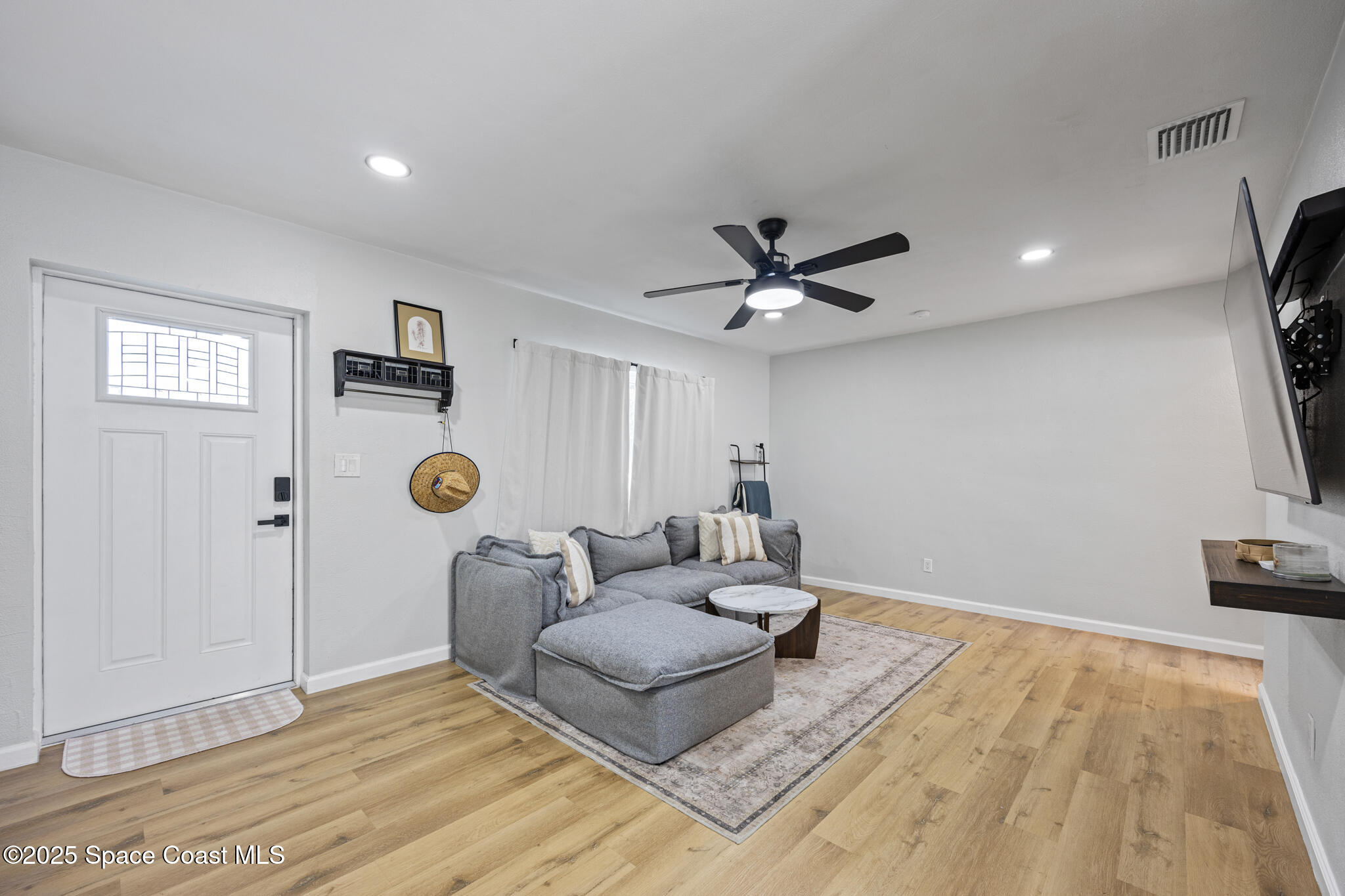 115 Primrose Lane Melbourne, FL 32901 - Photo 6 of 22 a living room with furniture and a flat screen tv