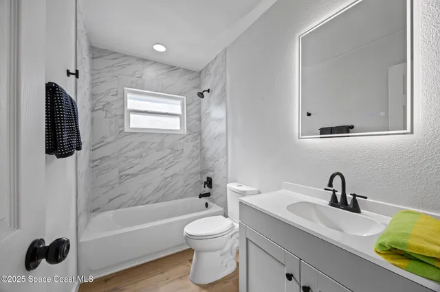 a bathroom with a sink toilet a bathtub and vanity
