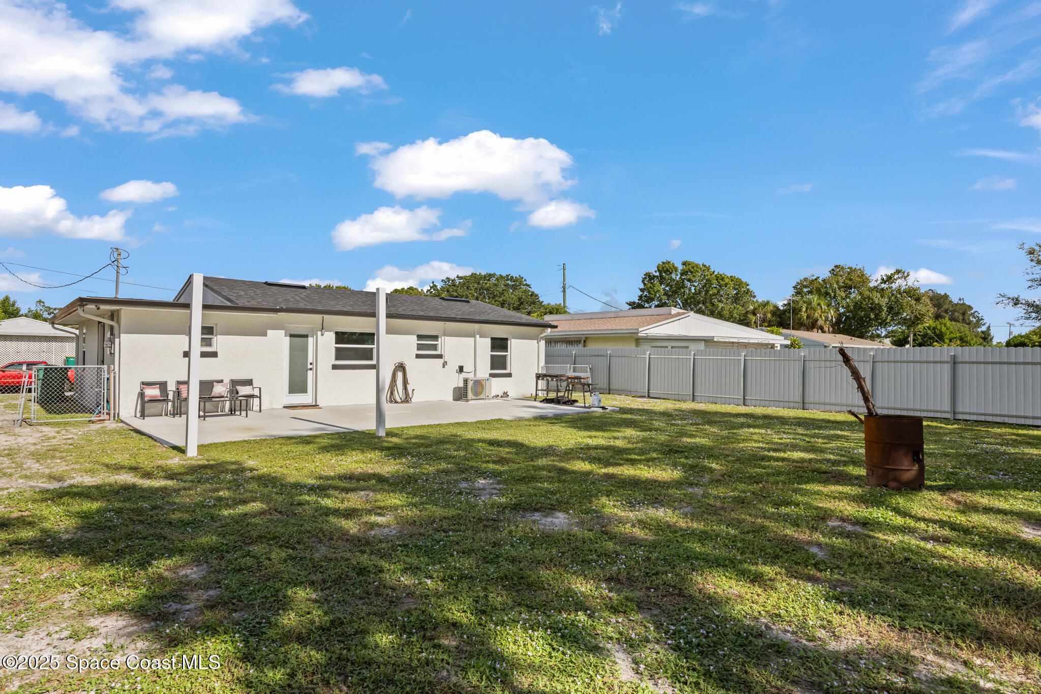 115 Primrose Lane Melbourne, FL 32901 - Photo 9 of 22 a white house with a big yard and large trees