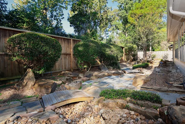 a view of backyard with outdoor seating and plants