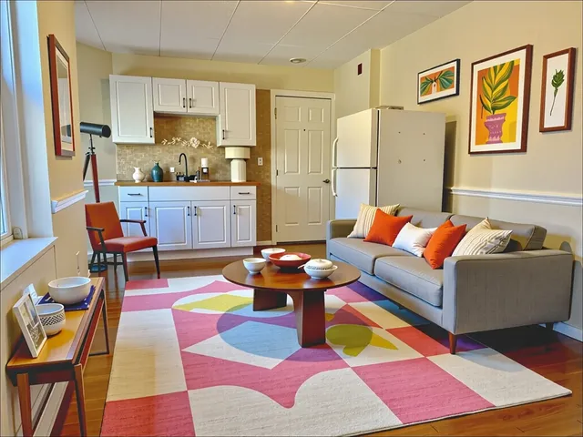 a living room with furniture and a dining table