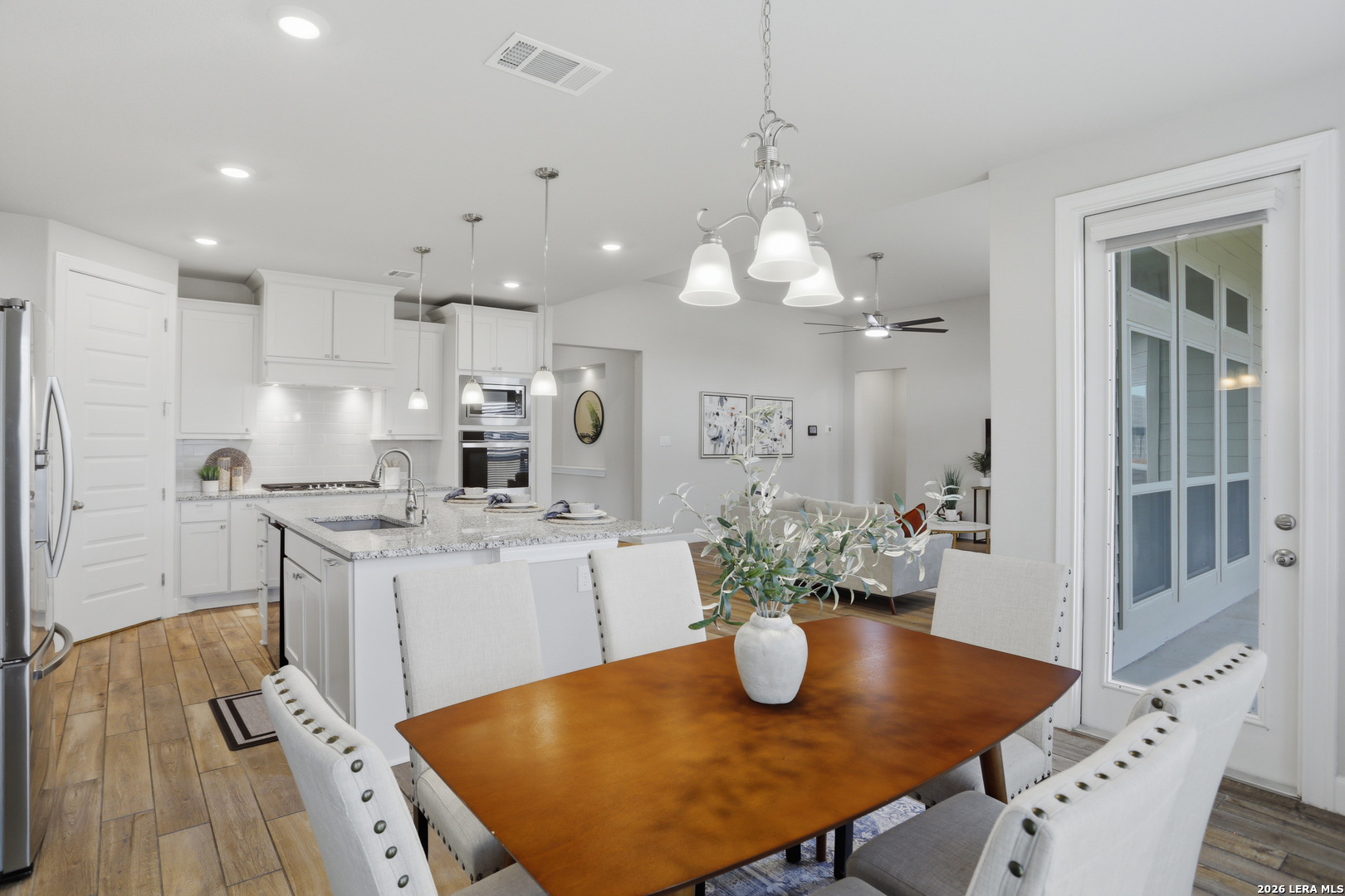 337 Misty Sails Cibolo, TX 78108 - Photo 15 of 50 a kitchen with stainless steel appliances granite countertop a dining table chairs and granite counter tops