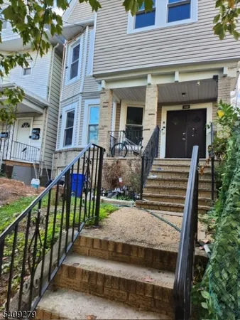 a view of a house with backyard porch and furniture