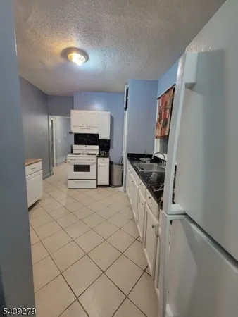 a kitchen with stainless steel appliances a refrigerator and a stove top oven