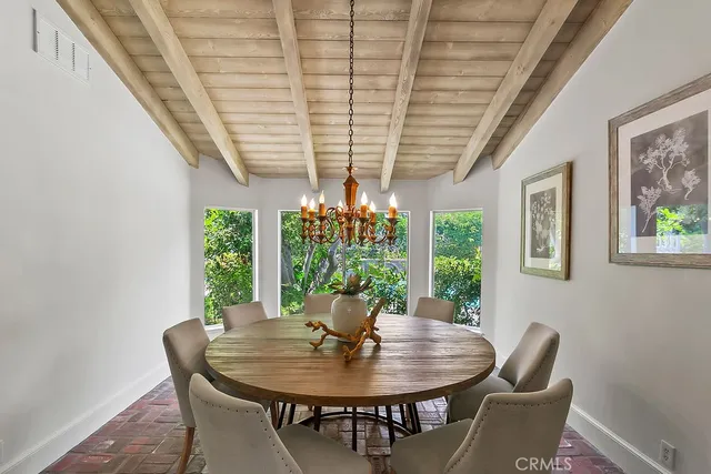 a view of a dining room with furniture wooden floor and chandelier