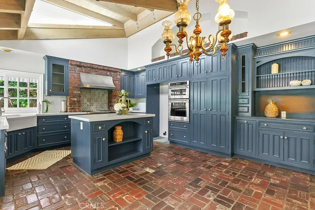 a kitchen with stainless steel appliances granite countertop a stove and a sink