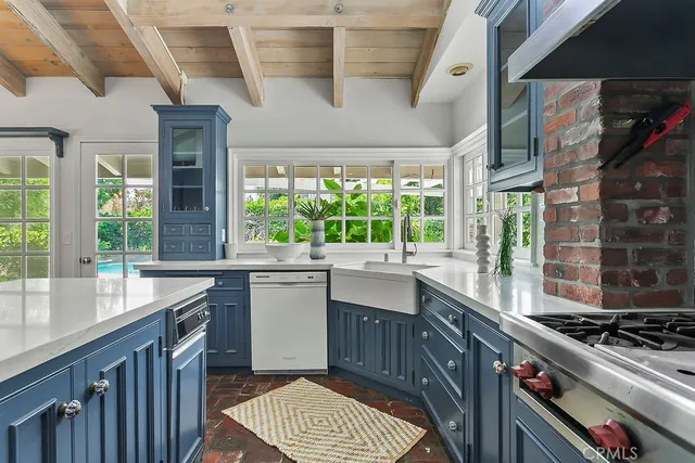 a kitchen with kitchen island a large window in it
