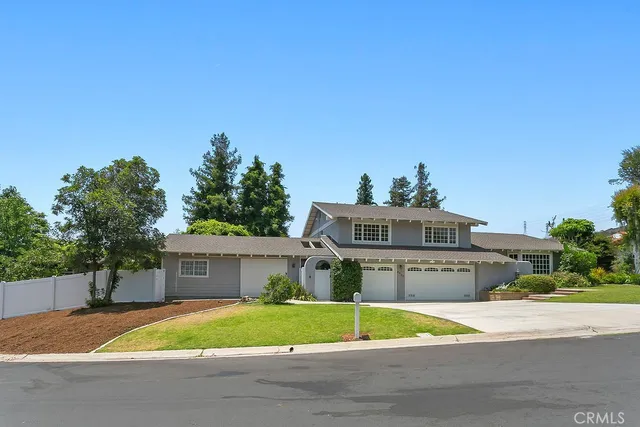 a view of a house with a street and a car parked