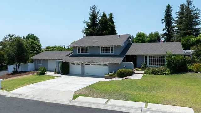 a front view of a house with a yard and a garage