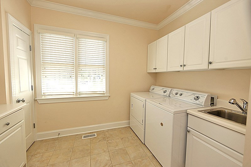 4310 Swarthmore Road Durham, NC 27707 - Photo 12 of 23 Large laundry off kitchen. Great storage shelves and cabinets and a utility sink. Laundry Room