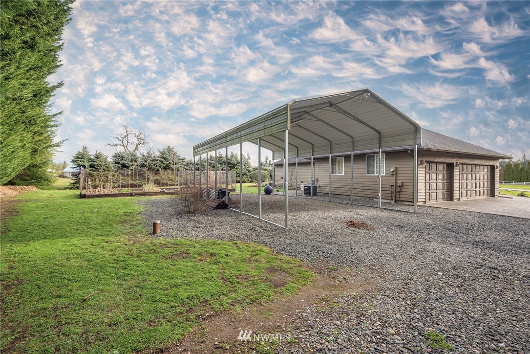 30719 Webster Road East Eatonville, WA 98328 - Photo 33 of 39 a view of a house with backyard and sitting area