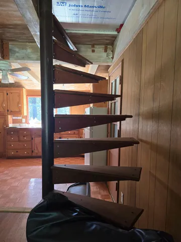 a view of staircase with a rug