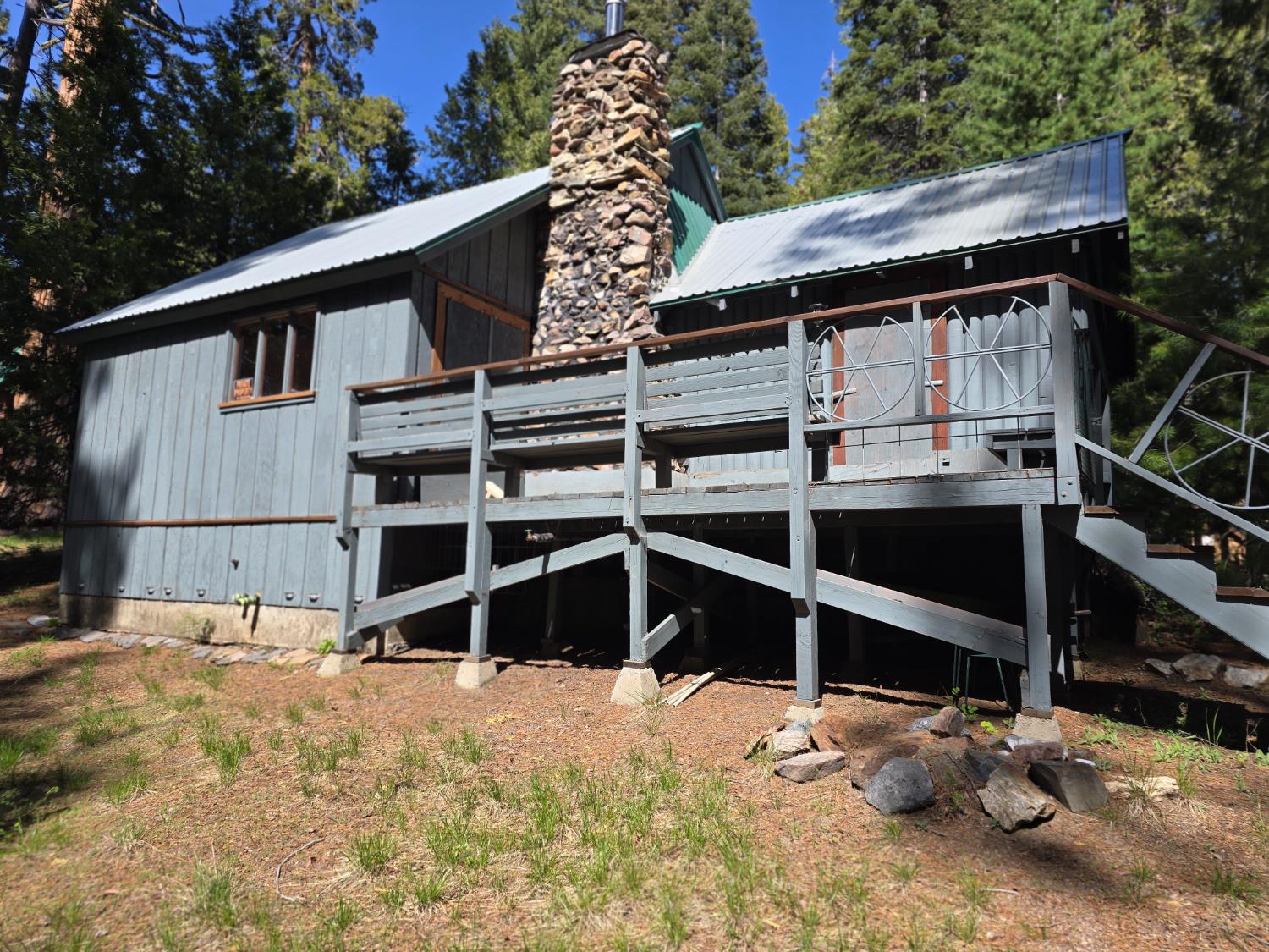83703 Hazel Lane Wilsonia, CA 93633 - Photo 16 of 22 a backyard of a house with a yard and garage