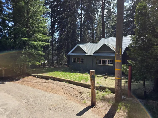 a view of house with yard