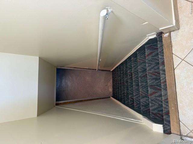 43038 Hanford Road Canton, MI 48187 - Photo 31 of 36 Carpeted staircase with a geometric pattern, featuring a white handrail and light-toned wall finishes
