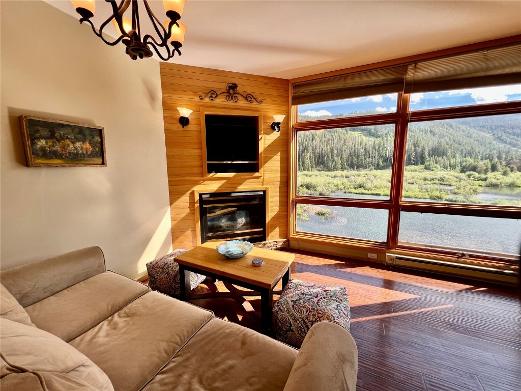 24 River Run Road, Unit 2911 Keystone, CO 80435 - Photo 3 of 24 a living room with furniture a flat screen tv and a floor to ceiling window
