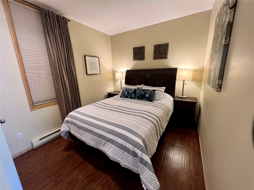 24 River Run Road, Unit 2911 Keystone, CO 80435 - Photo 8 of 24 a bedroom with a bed and wooden floor