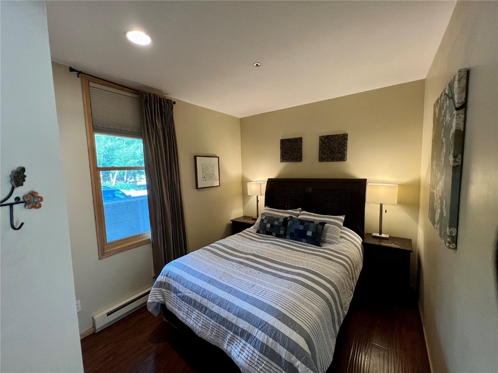 24 River Run Road, Unit 2911 Keystone, CO 80435 - Photo 9 of 24 a bedroom with a bed and wooden floor